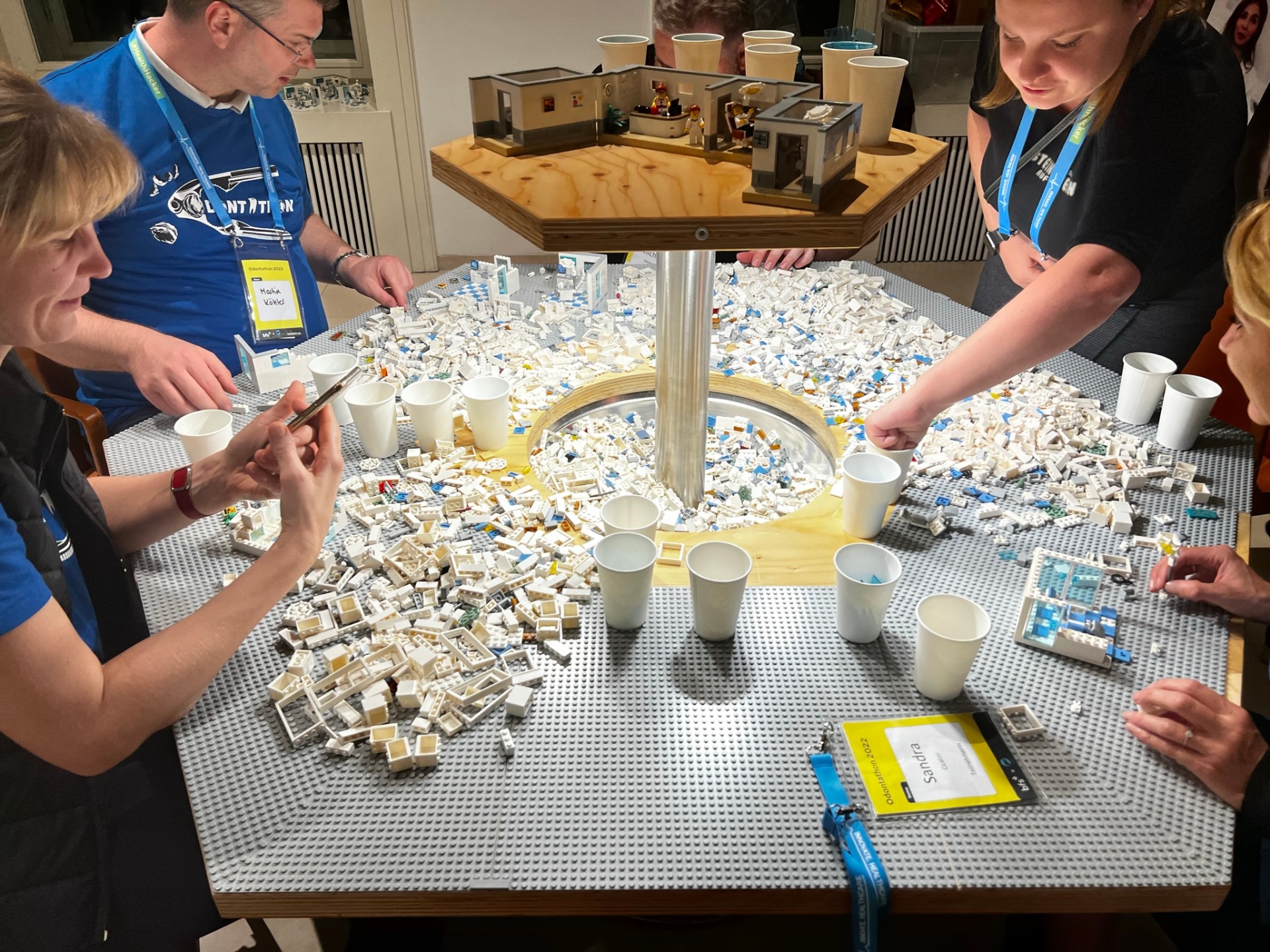 Workshop participants working with LEGO blocks around a table